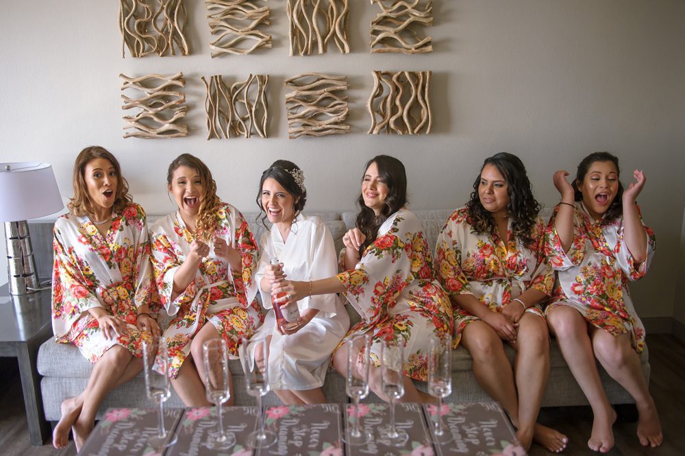 Candid bridesmaids pose for a photo before getting ready for their Florida wedding.